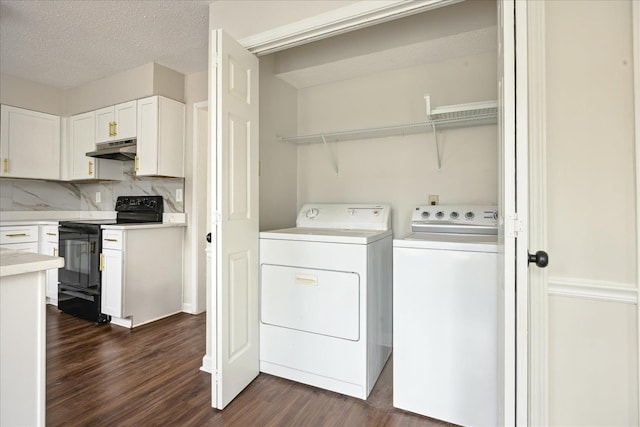 laundry area featuring dark wood-type flooring, separate washer and dryer, laundry area, and a textured ceiling