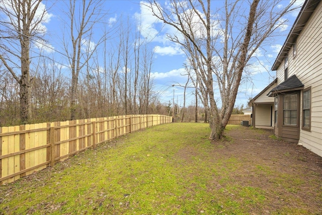 view of yard with fence and central AC