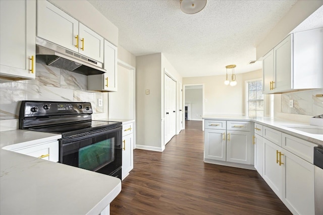 kitchen with under cabinet range hood, light countertops, a peninsula, electric range, and dark wood-style flooring