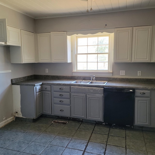 kitchen featuring a sink, dark countertops, dishwasher, and gray cabinetry