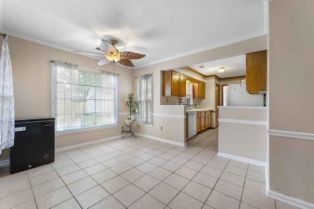 interior space with white appliances, light tile patterned floors, brown cabinetry, light countertops, and crown molding