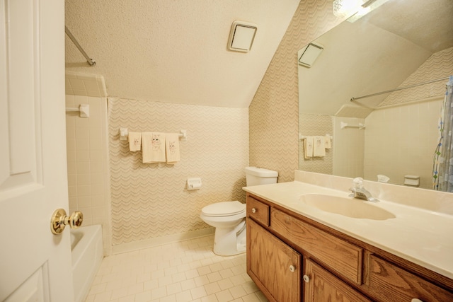 full bath with vanity, lofted ceiling, a textured ceiling, tile patterned floors, and toilet