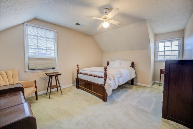 carpeted bedroom featuring baseboards, visible vents, and a textured ceiling