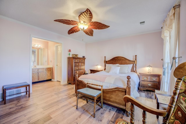 bedroom with visible vents, light wood-style flooring, ceiling fan, ensuite bathroom, and crown molding