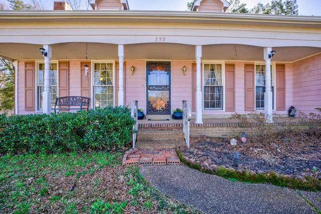 view of exterior entry with covered porch