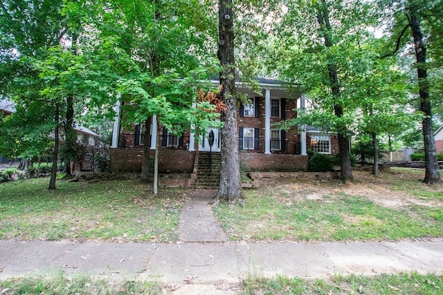 greek revival house featuring brick siding