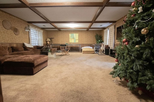 carpeted living area featuring wallpapered walls, beamed ceiling, a wainscoted wall, and coffered ceiling