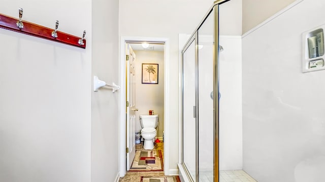 bathroom featuring a shower stall and toilet