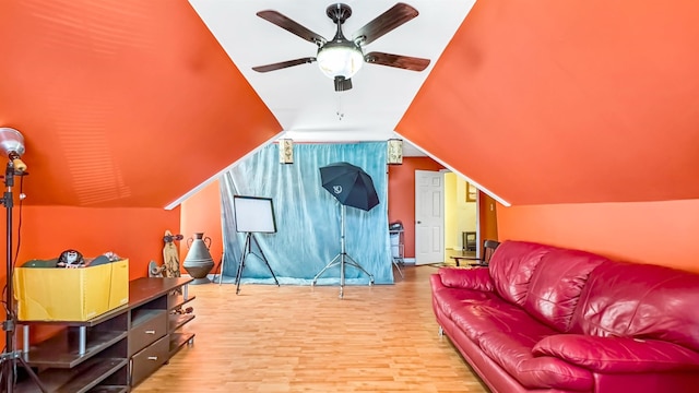 interior space featuring ceiling fan, wood finished floors, and vaulted ceiling