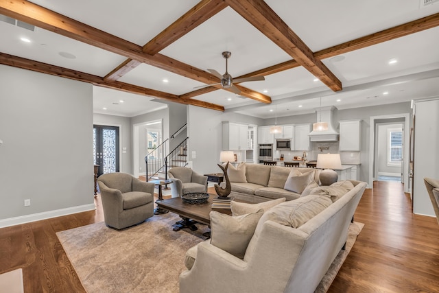 living area with dark wood-style floors, beam ceiling, coffered ceiling, and baseboards