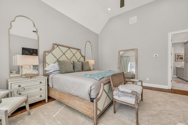 bedroom with wood finished floors, baseboards, visible vents, high vaulted ceiling, and ceiling fan