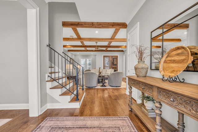 foyer featuring stairway, wood finished floors, baseboards, coffered ceiling, and beamed ceiling