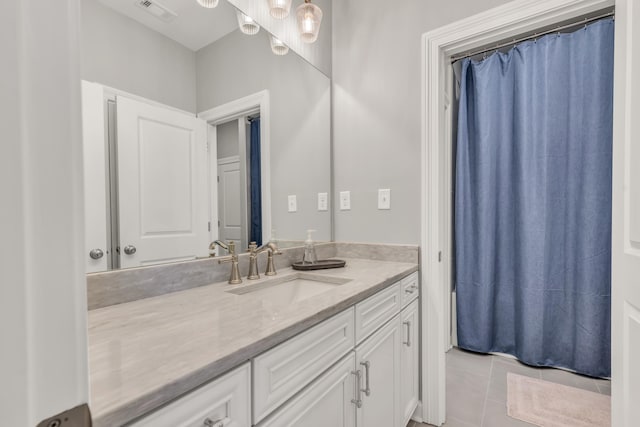 bathroom featuring tile patterned flooring, visible vents, and vanity