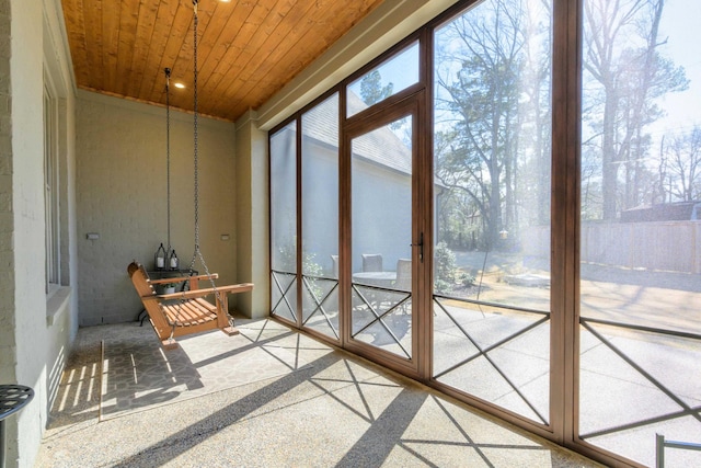 sunroom / solarium with plenty of natural light and wooden ceiling