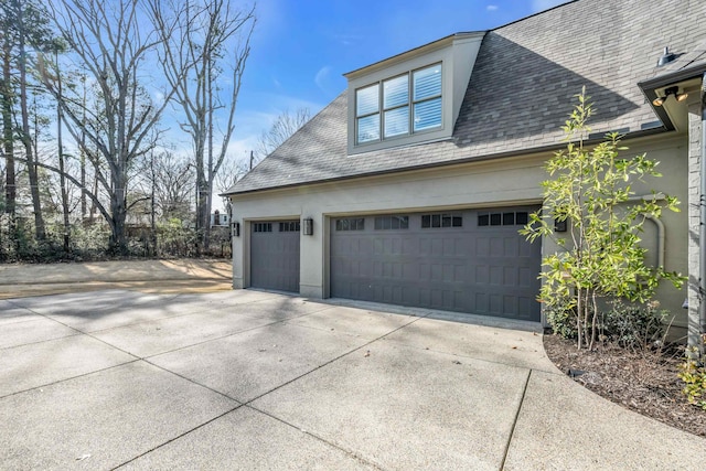 view of home's exterior featuring stucco siding and driveway