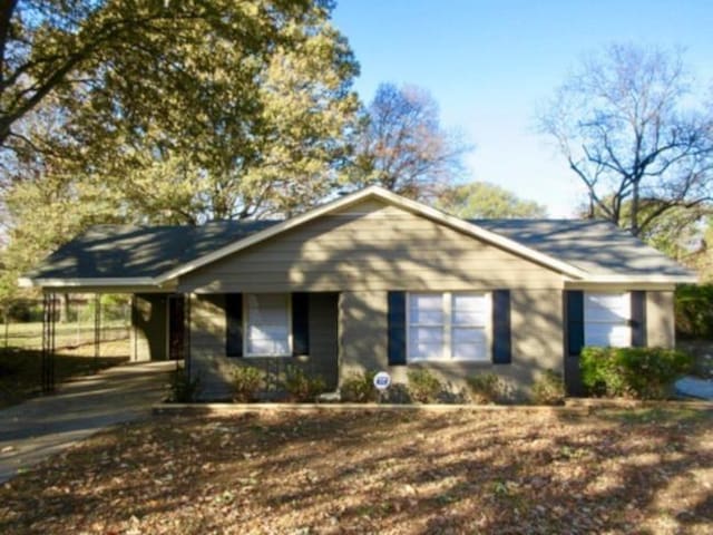 single story home with an attached carport and driveway