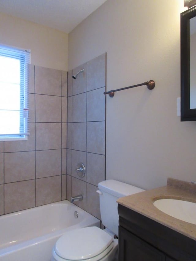 bathroom with vanity, bathing tub / shower combination, and toilet