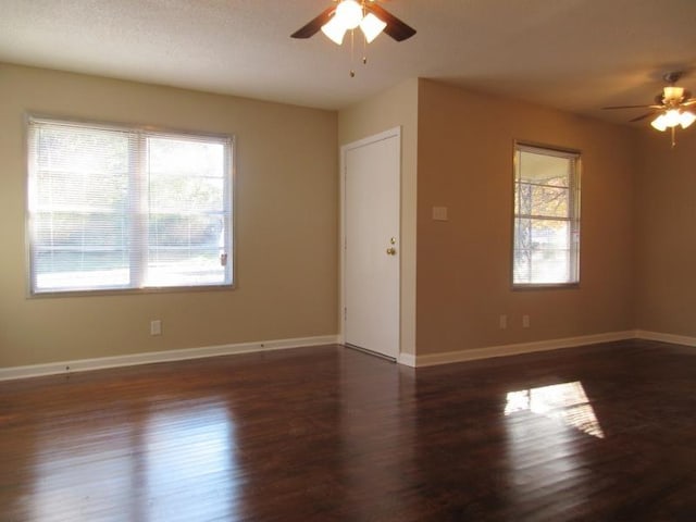 unfurnished room with wood finished floors, baseboards, and ceiling fan