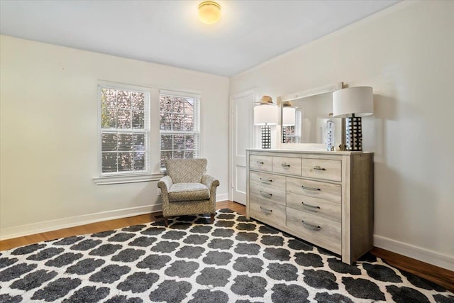 living area with baseboards and wood finished floors