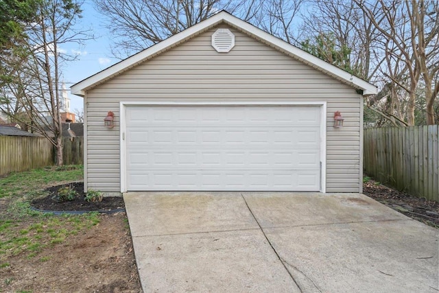 detached garage featuring fence