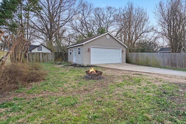 detached garage featuring fence