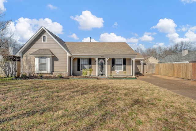 ranch-style home featuring stone siding, a porch, a front yard, and fence