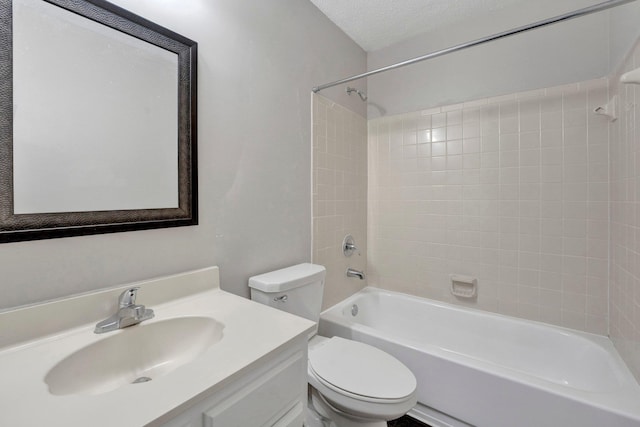 full bathroom featuring vanity, shower / bathing tub combination, toilet, and a textured ceiling