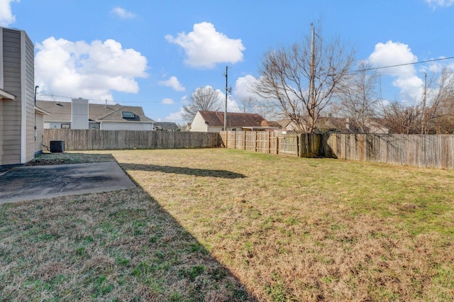 view of yard featuring a patio, central AC unit, and a fenced backyard