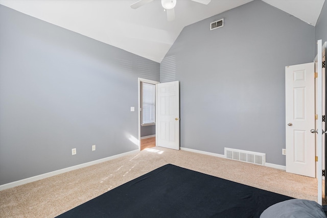 unfurnished bedroom with visible vents, carpet flooring, high vaulted ceiling, and baseboards