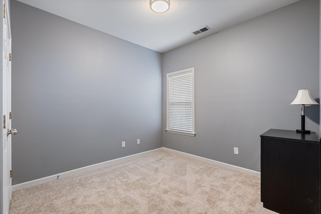 unfurnished room with visible vents, baseboards, and carpet