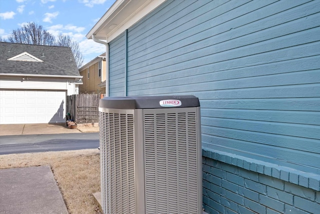 exterior details featuring cooling unit and fence