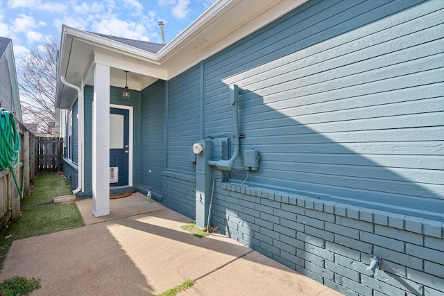 view of property exterior with a patio and a fenced backyard