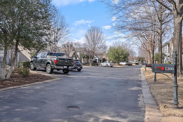 view of road with curbs and a residential view