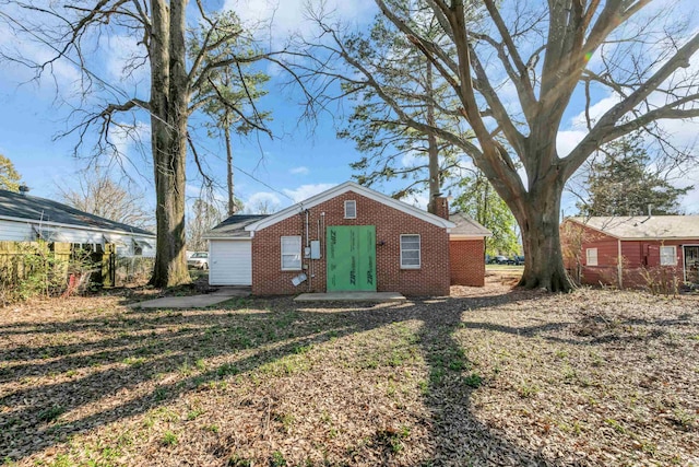 view of front of house featuring brick siding and a chimney