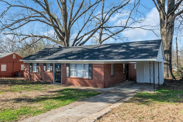 single story home featuring brick siding and roof with shingles