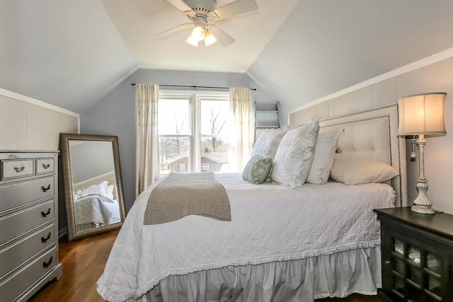 bedroom with vaulted ceiling, crown molding, dark wood-style flooring, and ceiling fan