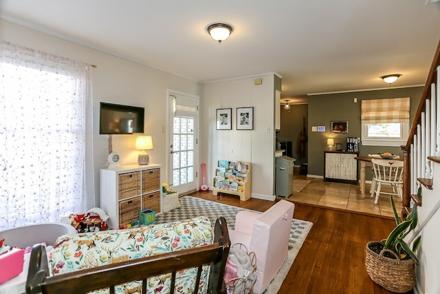 bedroom featuring wood finished floors, baseboards, and ornamental molding