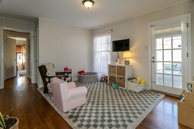 rec room featuring crown molding, baseboards, and wood finished floors