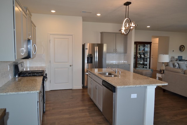 kitchen with visible vents, a sink, open floor plan, dark wood finished floors, and stainless steel appliances