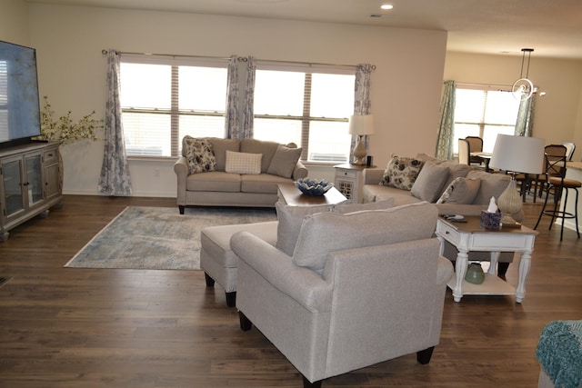 living area with recessed lighting, dark wood-type flooring, and baseboards