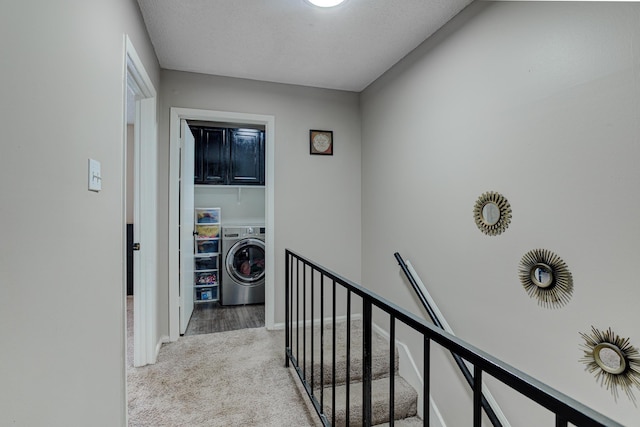 corridor featuring washer / dryer, carpet flooring, and an upstairs landing