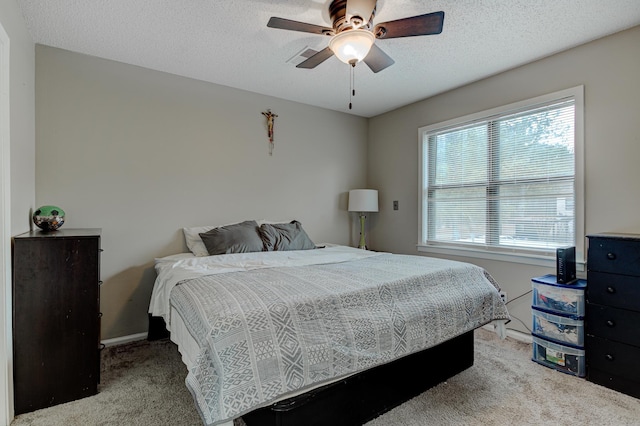 bedroom featuring carpet floors, a textured ceiling, and ceiling fan