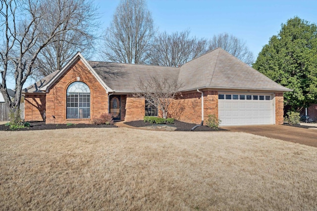 ranch-style house featuring concrete driveway, a garage, brick siding, and a front lawn