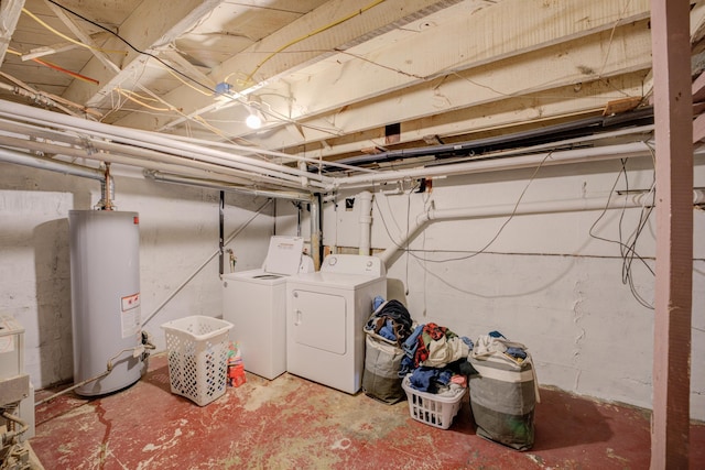 unfinished basement featuring water heater and washing machine and clothes dryer