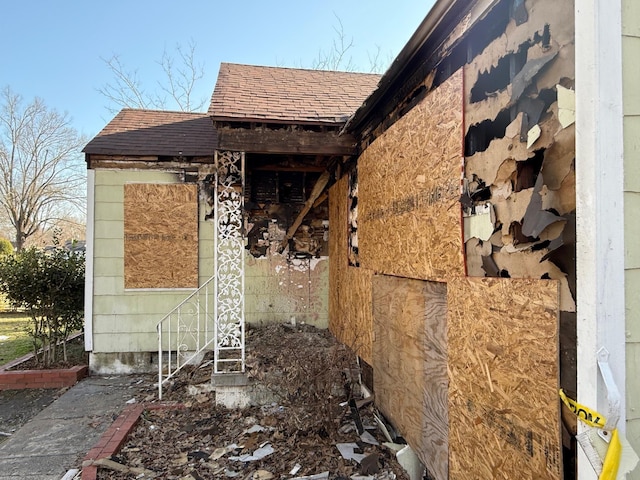 view of home's exterior featuring roof with shingles