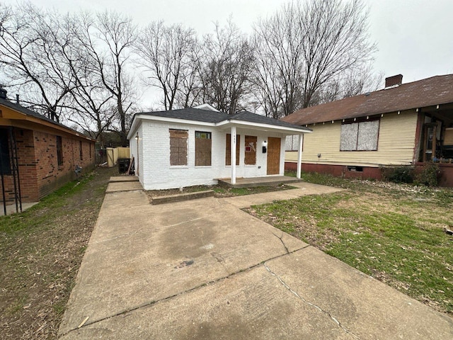 bungalow-style house with brick siding