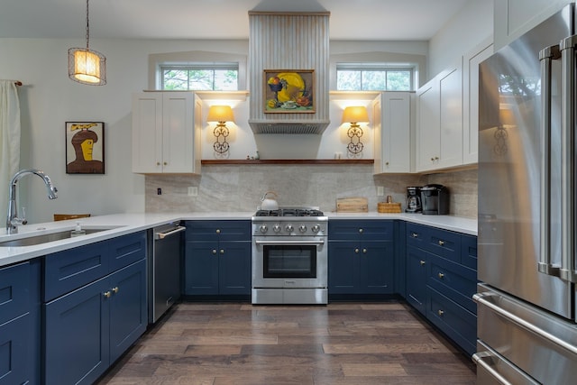 kitchen with premium appliances, a sink, blue cabinets, and open shelves