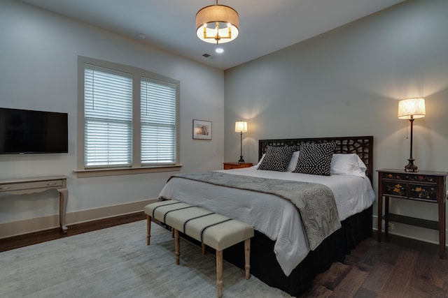 bedroom with recessed lighting, wood finished floors, visible vents, and baseboards