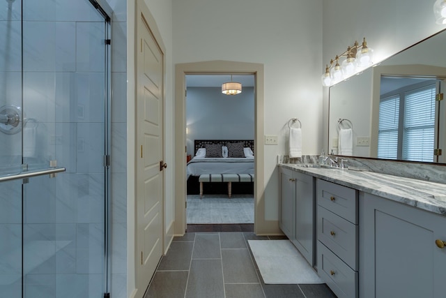 full bath featuring tile patterned floors, a stall shower, vanity, and ensuite bathroom