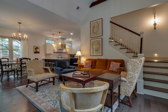 living room with visible vents, dark wood finished floors, stairs, vaulted ceiling, and an inviting chandelier